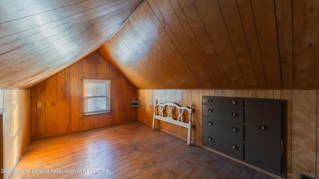 additional living space featuring lofted ceiling, wooden walls, hardwood / wood-style floors, and wooden ceiling