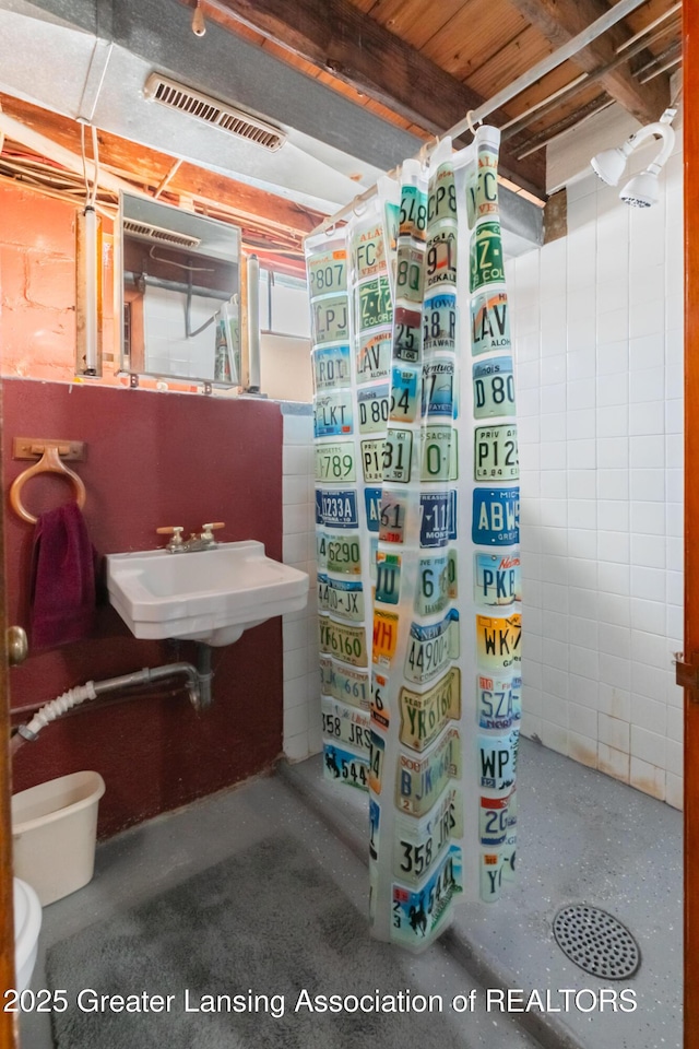 bathroom with curtained shower and sink