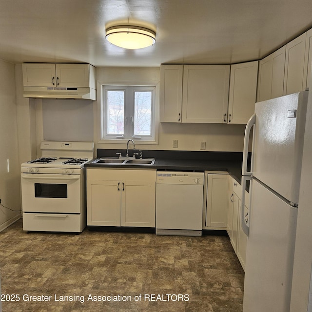 kitchen with white appliances, sink, and white cabinets