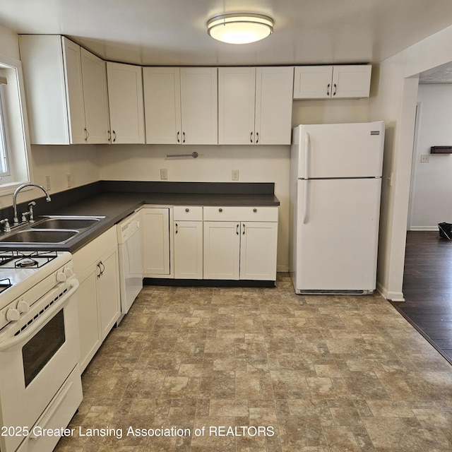 kitchen with white appliances, sink, and white cabinets