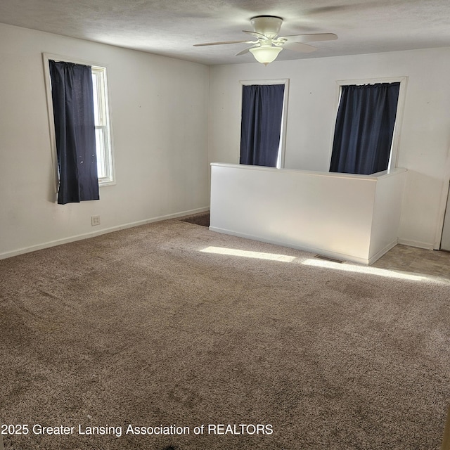 empty room featuring carpet and ceiling fan