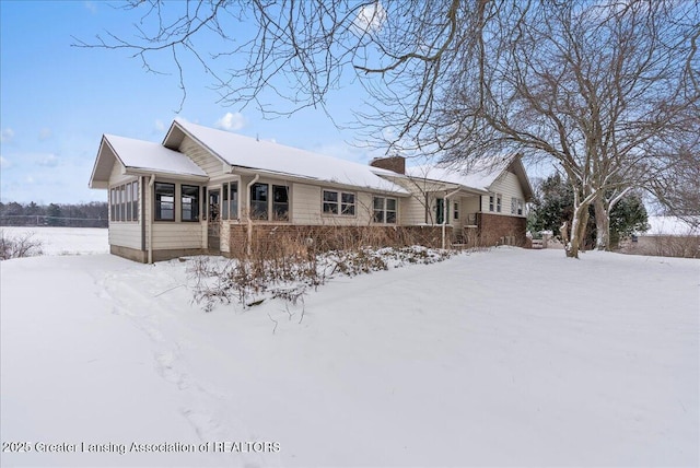 view of front of property featuring a sunroom