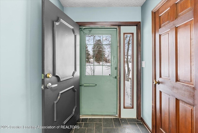 entryway with a textured ceiling