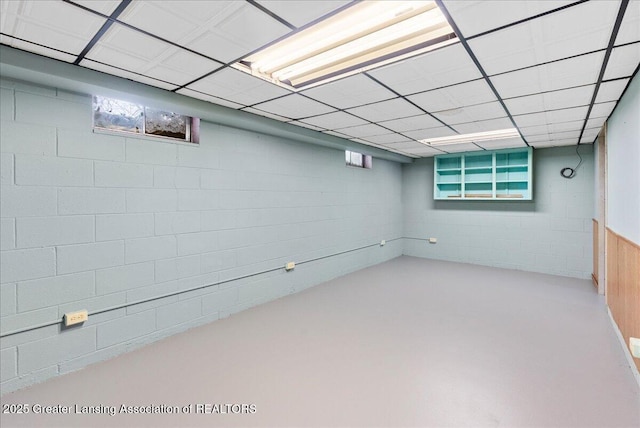 basement featuring a paneled ceiling