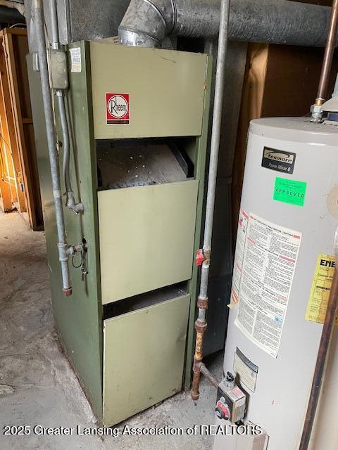 utility room featuring heating unit and gas water heater