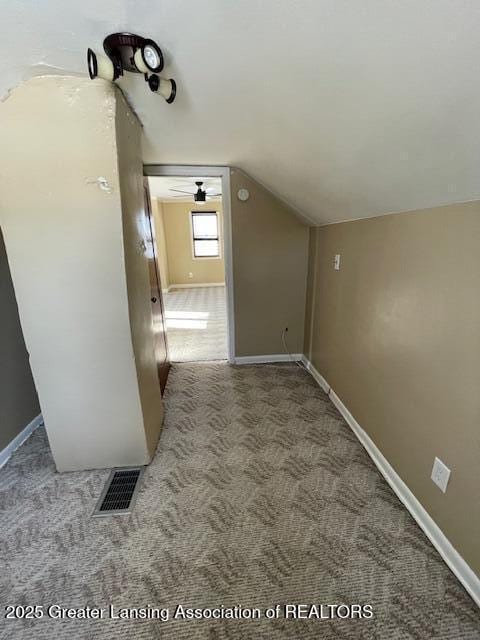 hall with vaulted ceiling and carpet