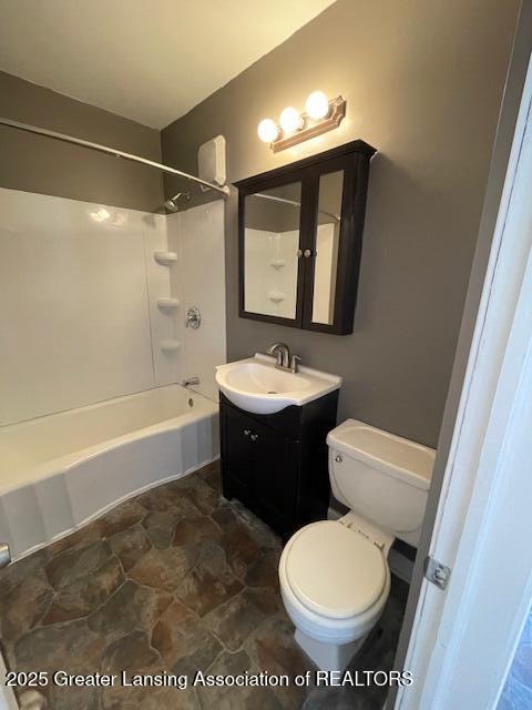 full bathroom featuring vanity, tub / shower combination, and toilet