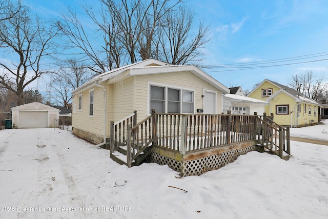 view of front of house featuring an outbuilding, a garage, and a deck