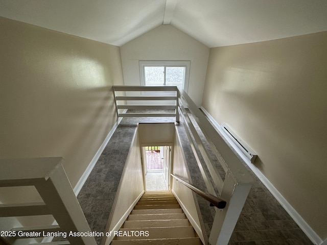 stairs with hardwood / wood-style flooring, a baseboard radiator, and lofted ceiling