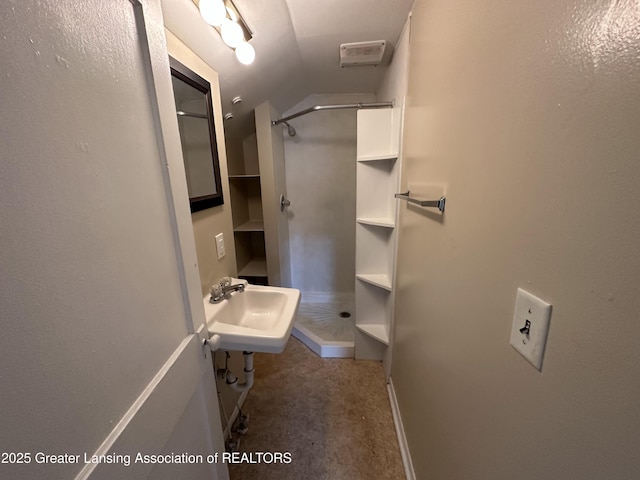 bathroom featuring vaulted ceiling and sink