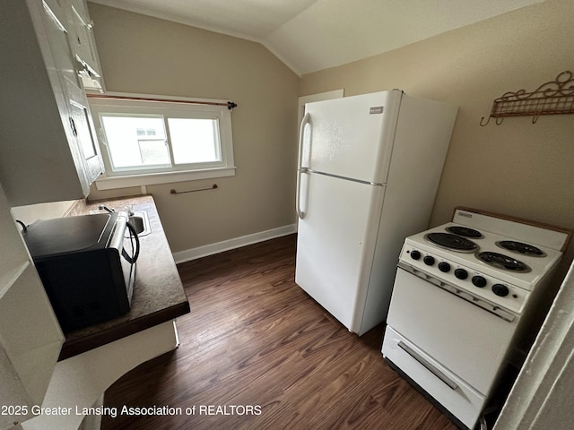 kitchen with vaulted ceiling, dark hardwood / wood-style floors, and white appliances