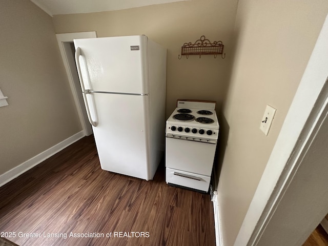 kitchen featuring dark wood-type flooring and white appliances