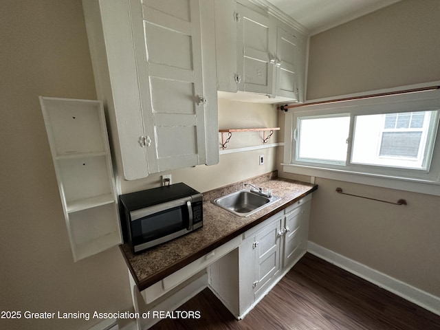 kitchen featuring sink, dark wood-type flooring, and white cabinets