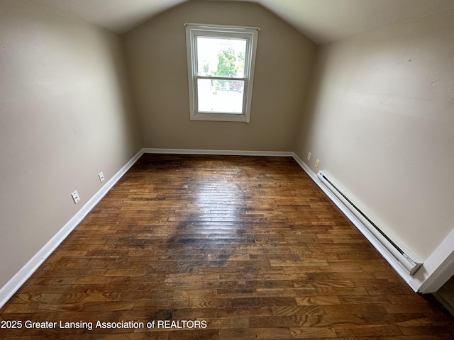 bonus room featuring dark hardwood / wood-style floors, vaulted ceiling, and a baseboard heating unit