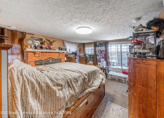 carpeted bedroom with a brick fireplace and a textured ceiling