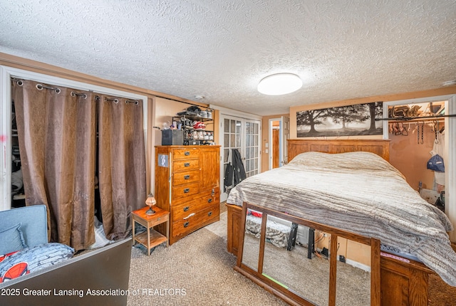 bedroom featuring light colored carpet and a textured ceiling