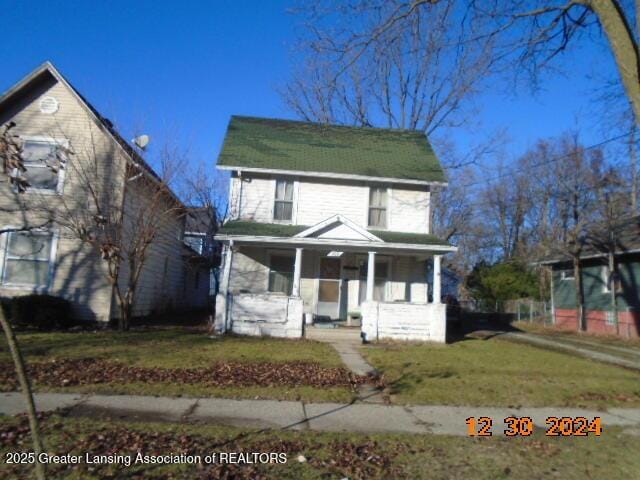 view of front property with a front yard and covered porch