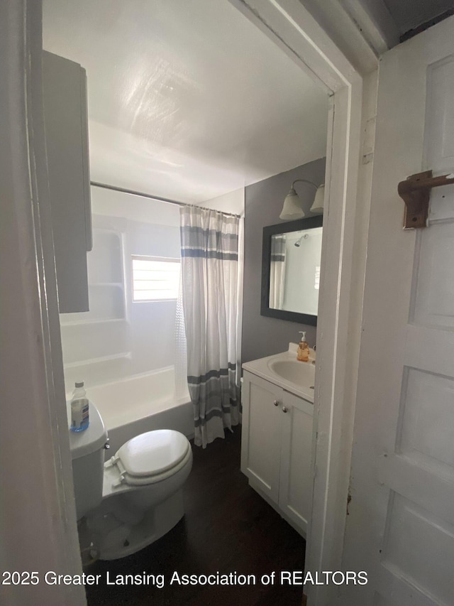 full bathroom with shower / bath combination with curtain, vanity, and toilet