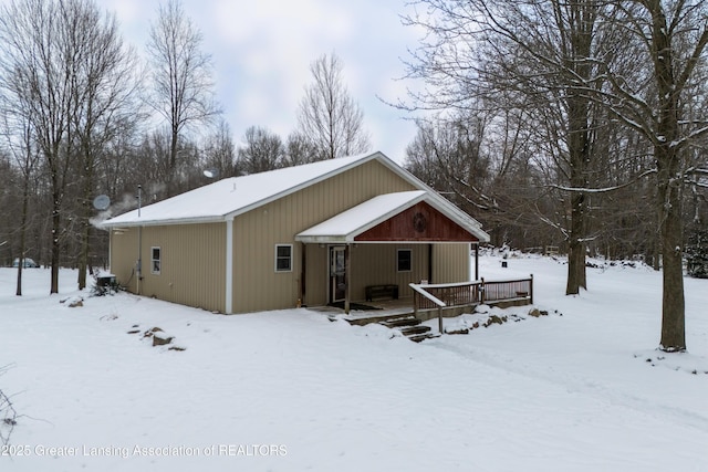 view of snow covered back of property