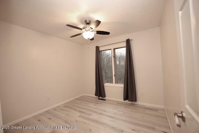 spare room featuring ceiling fan and light wood-type flooring