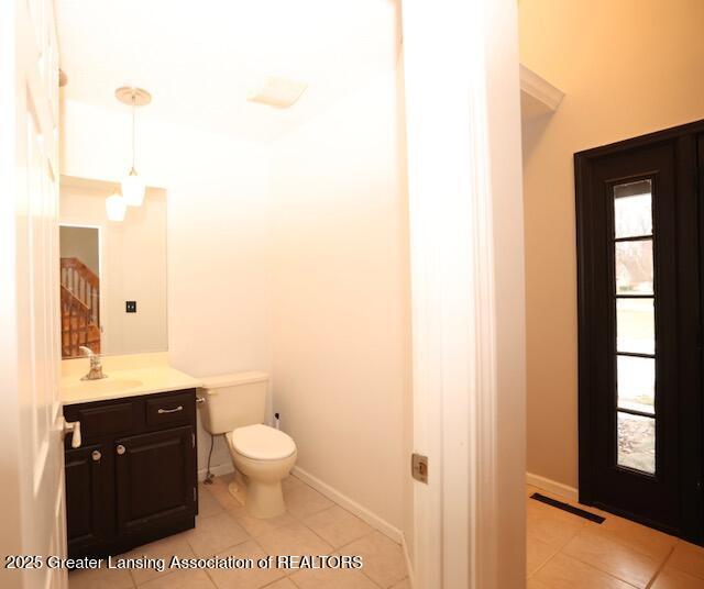 bathroom with tile patterned floors, vanity, and toilet