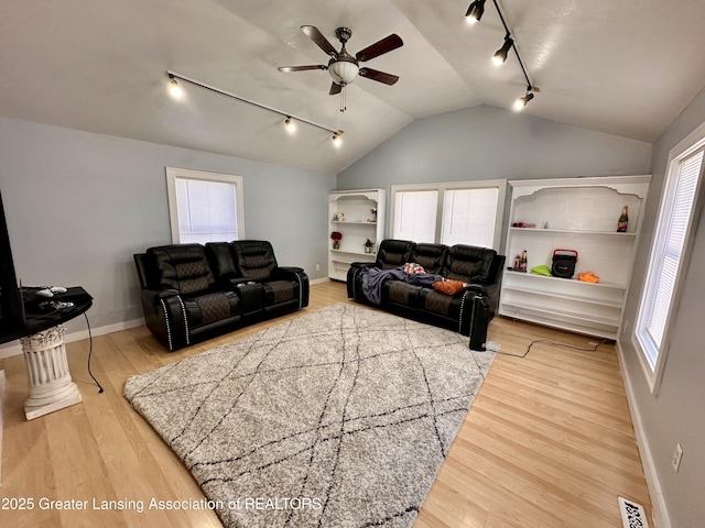 living room featuring lofted ceiling, wood-type flooring, and ceiling fan