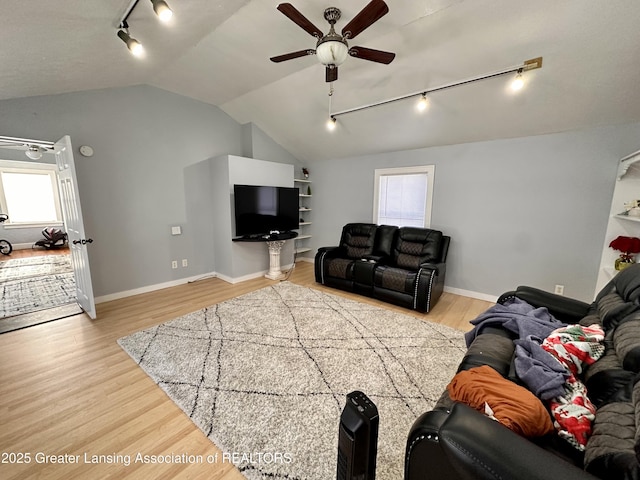 living room featuring hardwood / wood-style flooring, vaulted ceiling, and ceiling fan