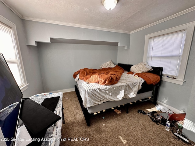 carpeted bedroom featuring ornamental molding and a textured ceiling