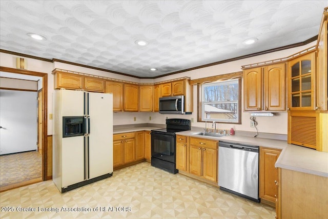 kitchen with crown molding, appliances with stainless steel finishes, sink, and a textured ceiling