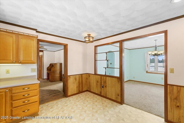 interior space featuring crown molding, an inviting chandelier, light carpet, and a textured ceiling