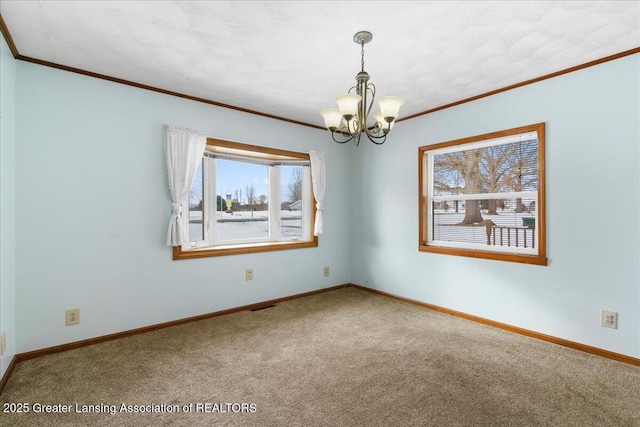 carpeted empty room with crown molding and a chandelier