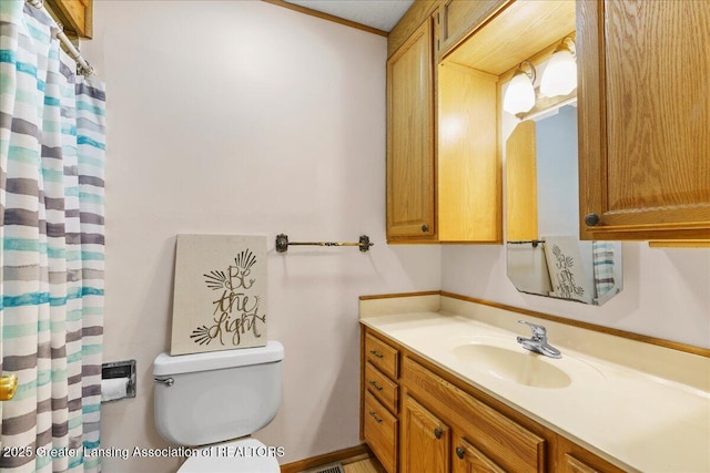 bathroom featuring vanity and toilet