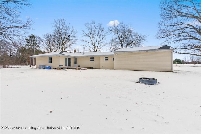 snow covered house with an outdoor fire pit