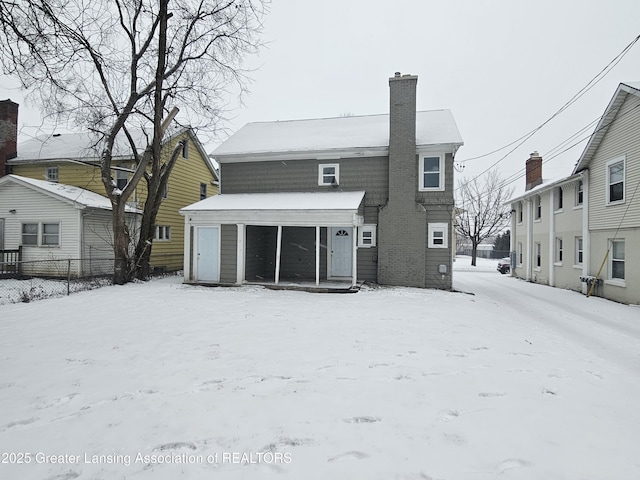 view of snow covered rear of property