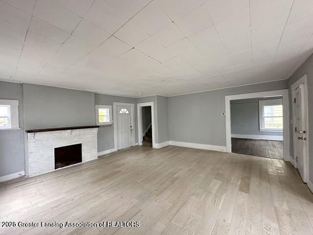 unfurnished living room featuring hardwood / wood-style flooring and a healthy amount of sunlight