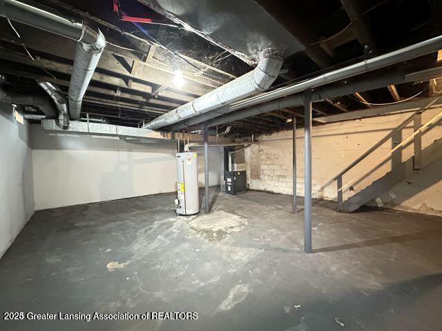 basement with water heater and heating unit