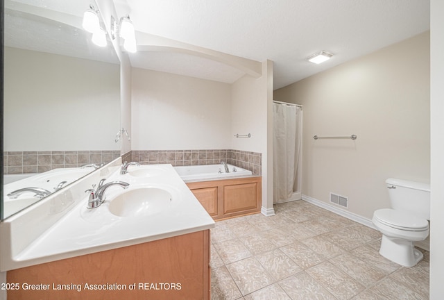 bathroom with walk in shower, vanity, toilet, and a textured ceiling