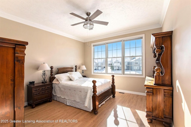 bedroom featuring crown molding, ceiling fan, a textured ceiling, and light wood-type flooring