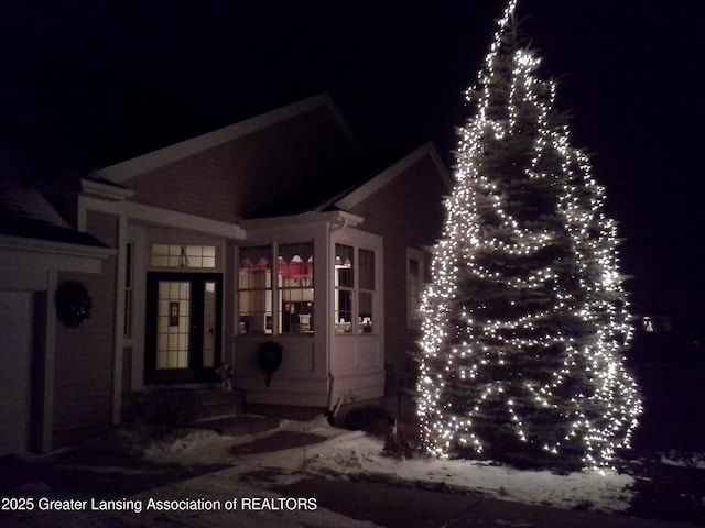 view of exterior entry at twilight