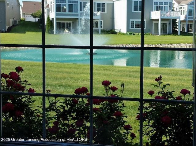 exterior space featuring a water view and a lawn