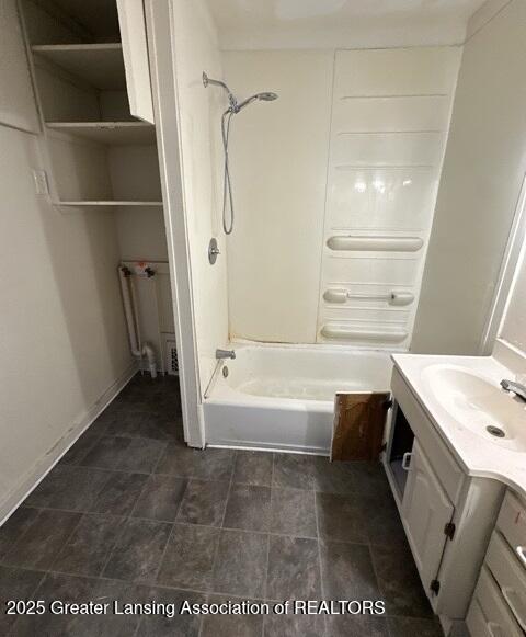 bathroom featuring bathing tub / shower combination, radiator, and vanity