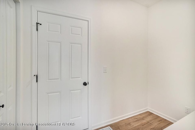 empty room featuring baseboards and wood finished floors