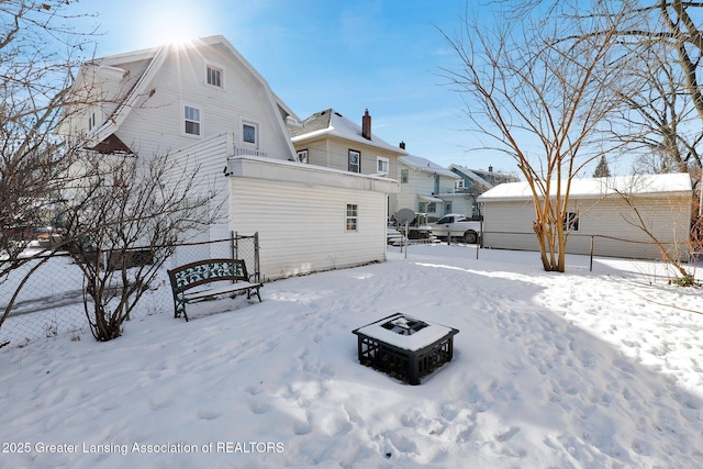 view of snow covered rear of property