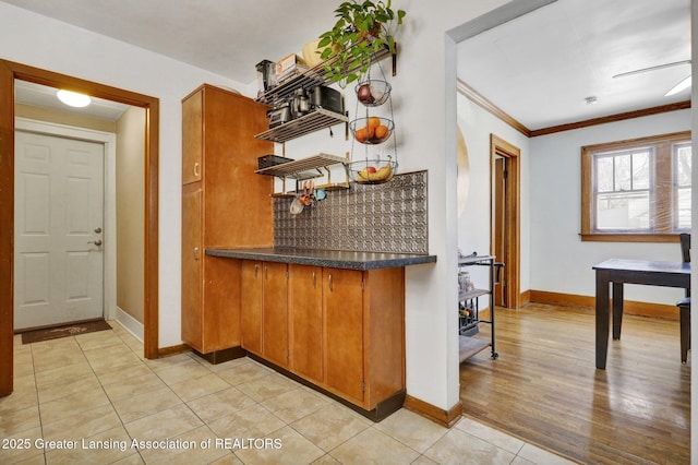 kitchen featuring light tile patterned floors and ornamental molding