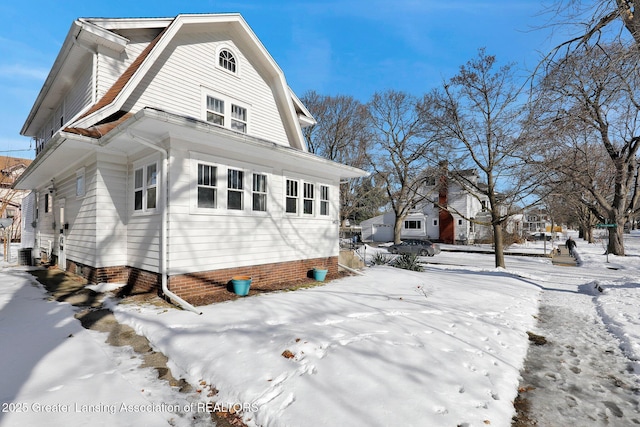 view of snowy exterior featuring cooling unit