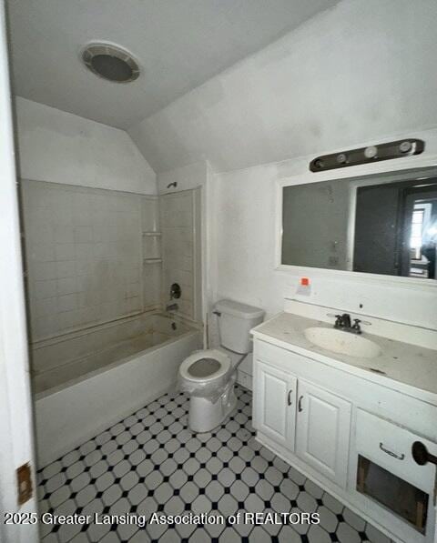 full bathroom with vanity, toilet, bathing tub / shower combination, and vaulted ceiling