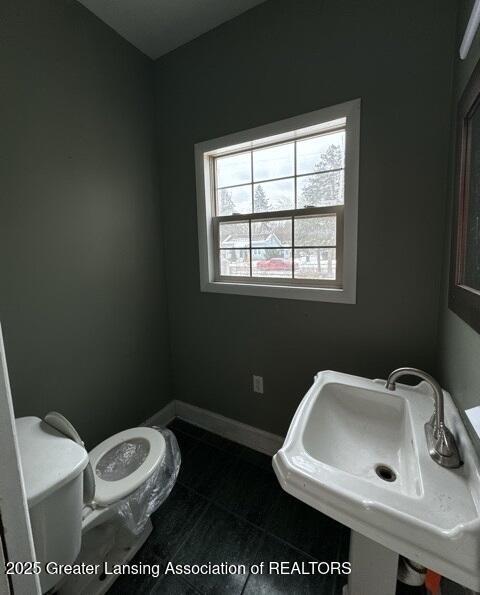 bathroom with tile patterned floors, toilet, and sink