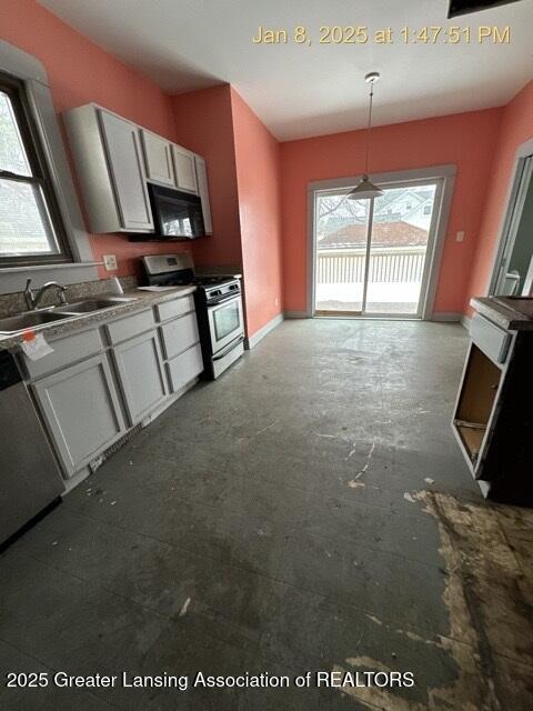 kitchen featuring stainless steel appliances, decorative light fixtures, sink, and gray cabinetry