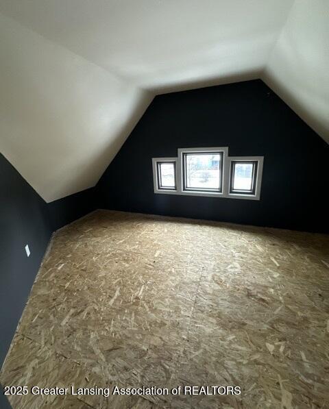 additional living space with vaulted ceiling