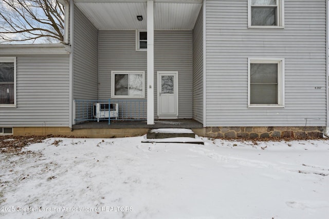 view of snow covered property entrance